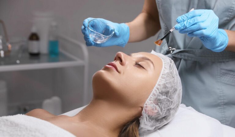 Cosmetologist applying chemical peel product on client's face in Medical Spa