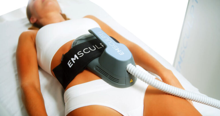 Fit woman in white bra and underwear gets Emsculpt treatment to burn muscle and build fat in the abs in Virginia.