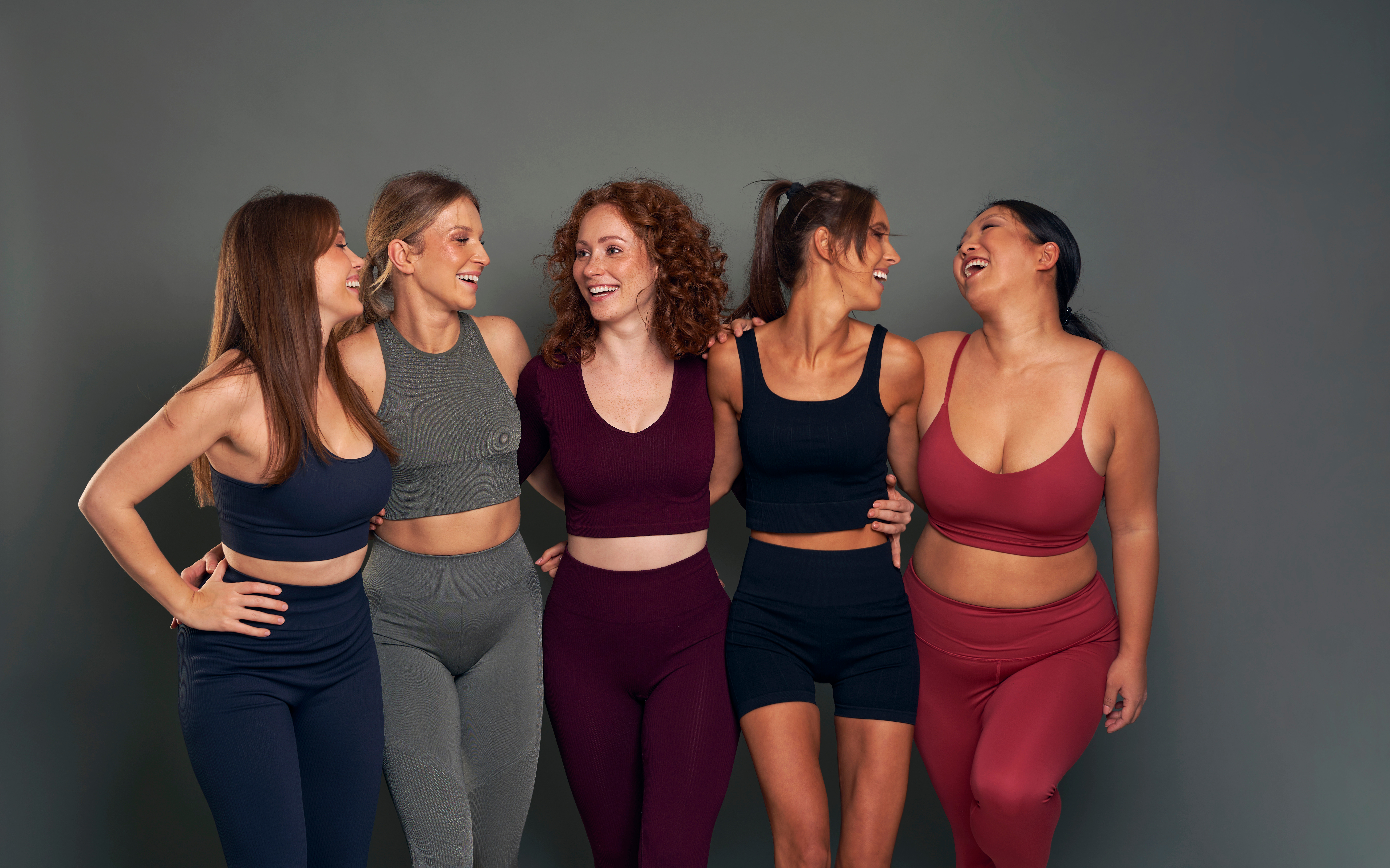 A group of woman of all shapes and sizes stand together smiling to model Semaglutide weight loss injections in McLean.