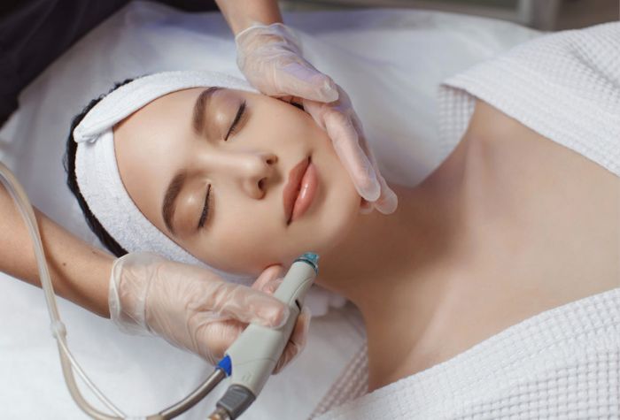 A woman undergoing hydrafacial, a service offered at Evexia Medspa in Tysons Corner, VA.