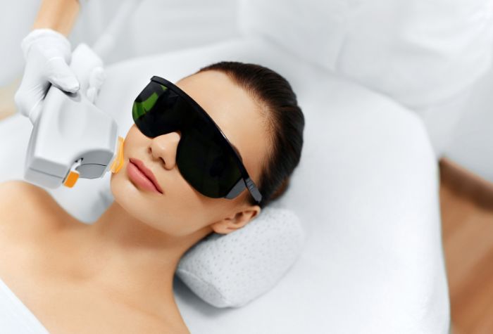 A woman undergoing IPL skin rejuvenation, a service offered at Evexia Medspa in Tysons Corner, VA.