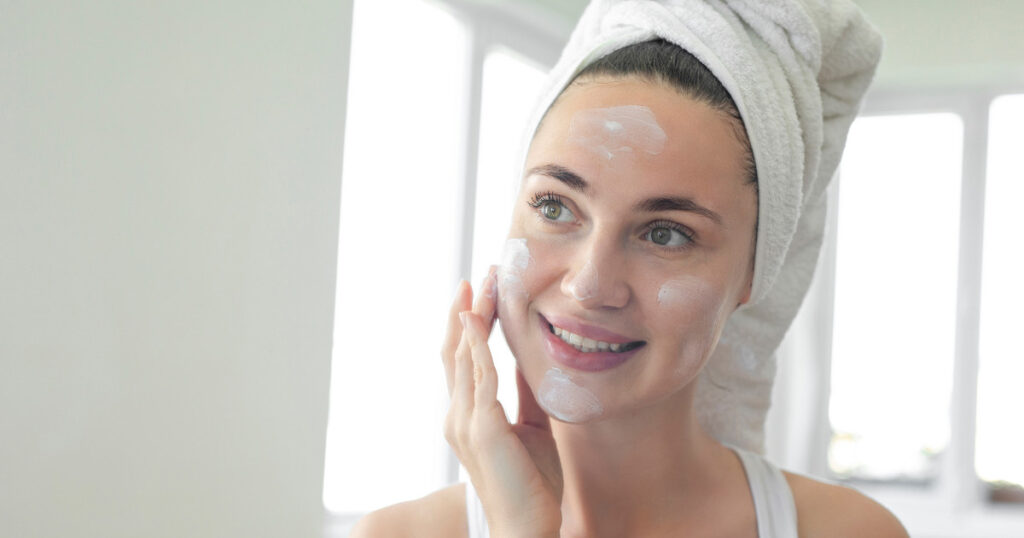 someone putting lotion on their face 1024x538 1