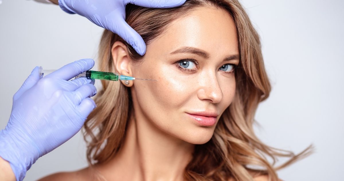 Cheek Filler vs. Jawline Filler: Which Creates Better Facial Balance? 1 Provider administering a cheek filler injection in a woman.