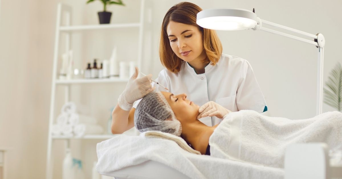 Provider administering Botox injections to a patient during a cosmetic treatment.