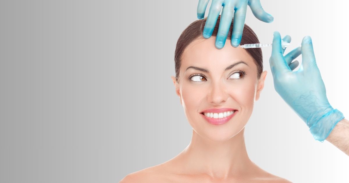 Woman receiving a Botox injection in the forehead at a medical spa.